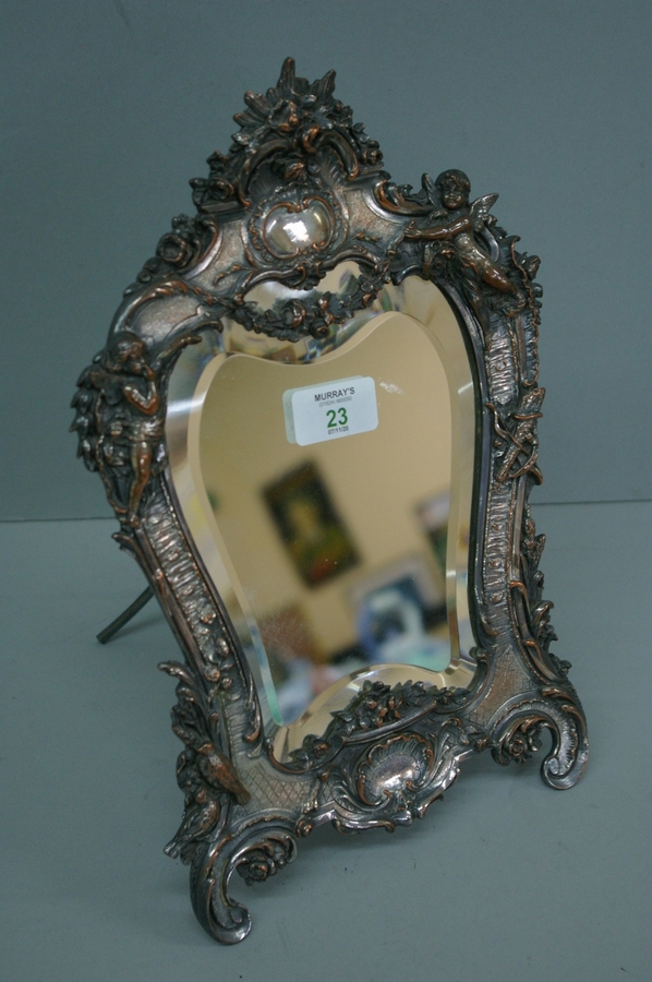 Edwardian silver plate on copper, bevel glass dressing table mirror with decoration of cherubs,