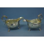 Pair of GIII silver sauce boats with shaped borders and scroll handles on hoof feet. London 1766. 14
