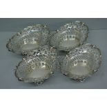 Set of four Edwardian pierced silver bonbon dishes of oval form with cherub mask decoration.