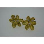 Pair of 18ct gold and diamond flower shaped ear clips - diam. 2.2 cm. Total weight 8.2g