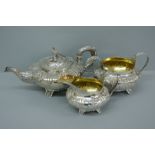 Good quality three piece chased silver tea service of circular form with decoration of flora and