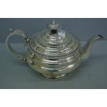 G IV silver circular tea pot with gadrooned border, acanthus decoration to handle. London 1825. 25.5