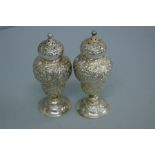 Pair of Victorian chased silver pepper pots with floral decoration (cased). London 1889. 3 ozt.