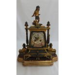 A 19thC French ormolu and bronze mantel clock with Egyptian decoration, porcelain dial chiming on