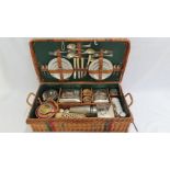 An Edwardian picnic hamper for four persons complete with spirit stove, kettle, etc.