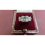 A platinum princess-cut three stone diamond ring 2.43 carat. The central diamond assessed at 1.00