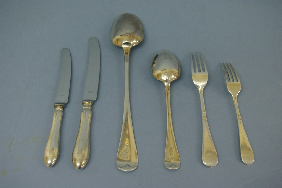 An Edwardian set of silver flatware of plain form for twelve persons consisting of twelve serving