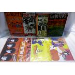 A collection of The Beatles modern metal wall signs plus two tea trays