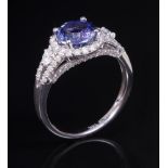 14kt. White Gold, Tanzanite and Diamond Ring , center prong set round cut tanzanite, wt. approx. 1.