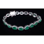 14 kt. White Gold, Emerald and Diamond Bracelet , comprised of 18 prong set oval mixed cut emeralds,