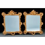 Pair of Italian Rococo Carved and Gilded Mirrors , probably 19th c., floral and shell crest, pierced