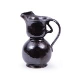 George Ohr Art Pottery Cream Pitcher , ribbon handle, glossy black glaze, base stamped "G.E. Ohr/