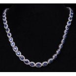 14 kt. White Gold, Sapphire and Diamond Necklace , comprised of 51 prong set oval mixed cut
