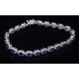 14 kt. White Gold, Sapphire and Diamond Bracelet , comprised of 23 oval mixed cut sapphires, total