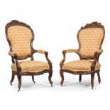 Two American Rococo Carved Mahogany Parlor Armchairs , mid-19th c., each with floral and foliate