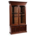 American Walnut Gun Cabinet , late 19th c., molded cornice, two glazed arched doors, 9 gun slots,