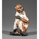German Porcelain Figure of a Seated Monkey , crossed lines mark, h. 8 in . Provenance: The Estate of