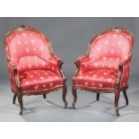 Pair of American Rococo Carved Mahogany Bergeres , barrel back, floral crest and seat rail, padded