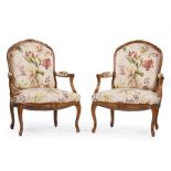 Pair of Regence-Style Fruitwood Fauteuils , foliate and cabochon crest, padded arms, cabriole