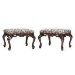 Pair of Baroque-Style Ottomans , pierced scrolled apron, cabriole legs, scrolled toes, h. 19 in., w.