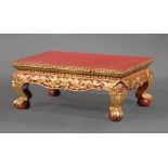 Asian Gilt and Lacquered Low Table , floral and foliate molded top, keyed frieze, dragon mask knees,