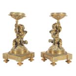 Pair of Napoleon III Polished Bronze Figural Candlestands , late 19th c., cherubs modeled in