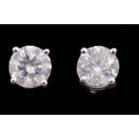 Pair of 18 kt. White Gold and Diamond Stud Earrings , centered with 2 prong set round brilliant