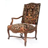 Regence-Style Carved Walnut Fauteuil , foliate carved arms, needlepoint upholstery with nailhead