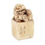 Chinese Soapstone Seal , carved with a Buddhist lion cradling its cub, carved chop, h. 3 1/2 in., w.
