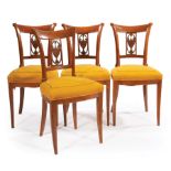 Four Continental Neoclassical Walnut Side Chairs , incurvate scrolled backs, swagged urn splats,