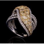 18 kt. White and Yellow Gold and Colorless and Yellow Diamond Ring , pavé-set with oval-cut and