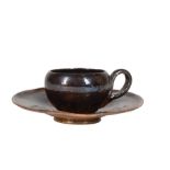 George Ohr Pottery "Poop" Demitasse Cup and Saucer , brown glaze, the cup signed "BILOXI", the