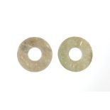 Two Chinese Pale Celadon Green Jade Bi Disks , carved with C scrolls, dia. 1 3/4 in. and 1 7/8