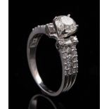 Platinum and Diamond Ring , center raised prong set round brilliant cut diamond, wt. approx. 1.15