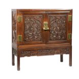 Chinese Hardwood Cabinet on Stand , early 20th c., case with two doors carved with dragons, sides