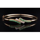 14 kt. Yellow Gold, Emerald and Diamond Bangle Bracelet , set with 16 small round emeralds and 7