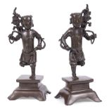 Pair of Chinese Bronze Figural Incense Stick Holders , Qing Dynasty (1644-1911), each modeled in