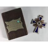 An enamelled Nazi mother's cross, dated '16 December 1938' to reverse, together with a miniature