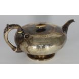 A Victorian silver teapot by John Tapley, of compressed globular form and with engraved, scrolling