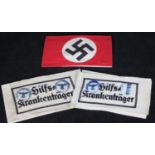 A WWII Third Reich NSDAP Armband, with central printed Swastika to a red ground, together with two