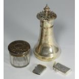 A small collection of assorted silver items including a caster of plain design, hallmarked London,