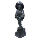 A carved, ebonized wooden figure of a Spanish Fisherman stood with his foot upon a tree stump,