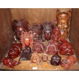 Sixteen various carved hardwood Oriental masks, the largest 30cm high