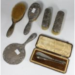 A five-piece silver backed brush and mirror set by Gorham Manufacturing Co. hallmarked Birmingham,