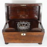 A 19th century rosewood sarcophagus tea caddy, the hinged top enclosing compartmented interior