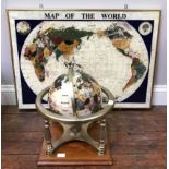 A gemstone globe suspended on brass stand with integral compass, raised on wooden platform base,