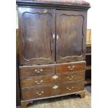 A Victorian stained mahogany linen press, the shaped cornice above a pair of panelled doors