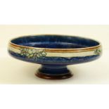 A Royal Doulton glazed stoneware shallow pedestal bowl stamped ?W.T. Lamb & Sons, compliments Xmas