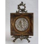 A reconstituted marble classical bas-relief roundel of putto, in gilt frame, 30x30cm, together