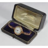 A ladies 9ct gold cocktail watch, the white enamel dial with Arabic numerals denoting hours, on